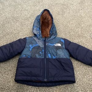 Worn twice. 3-6 month blue pattern lined The North Face Jacket.
